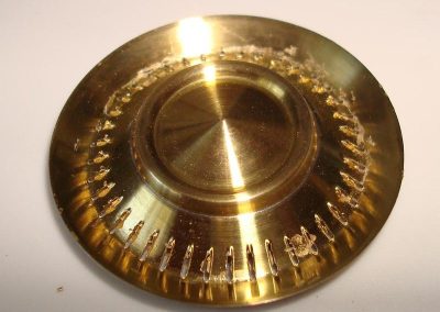A mill with a slitting saw was used to cut 40 slits on the cap surface.
