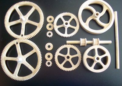 Several wooden gears to drive the hay baler mechanism.