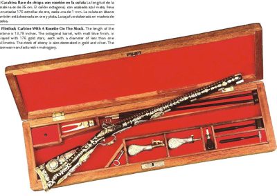 Another miniature flintlock carbine, this one has a rosette on the stock. 