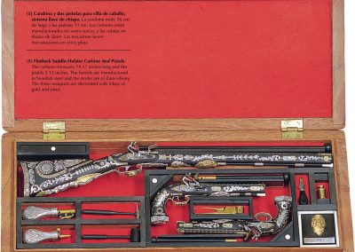 This ornate set includes a flintlock saddle holster carbine and pistols. 