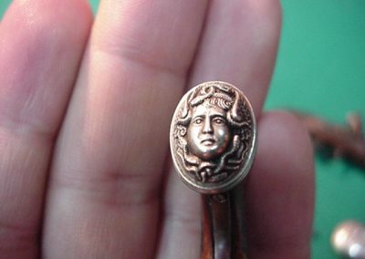 A close-up detail of the Medusa head detail from the butt plate.