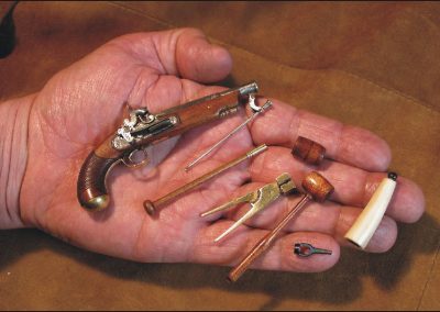 A miniature Miquelet percussion-lock pistol.