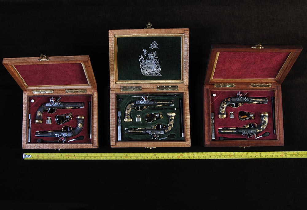 1/4 Scale Regulation Pistol Sets Three sets of 1/4 scale regulation pistols for various officers.