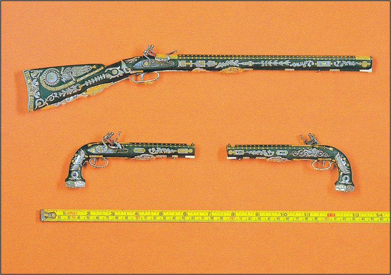Miniature Rifle and Pistols A miniature rifle and pair of matching pistols.