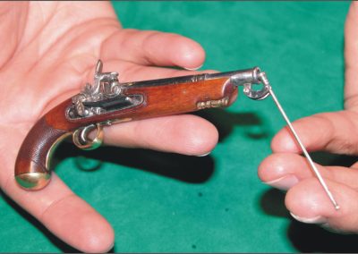 This tiny flintlock pistol features a clever built-in ram.