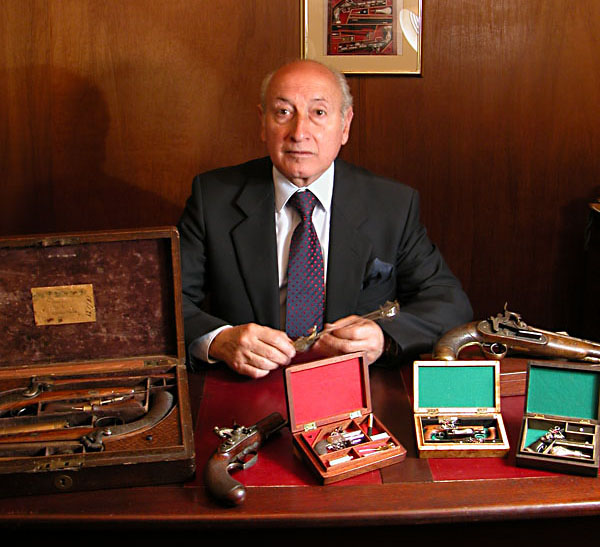Antonio Rincón Antonio Rincón, of Columbia, poses with several of his exceptional antique firearms.