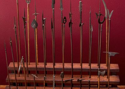 A miniature collection of ancient pikes, battle axes, maces, and more weapons.