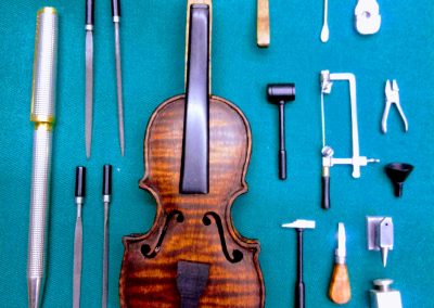 Antonio's progress on a miniature violin.