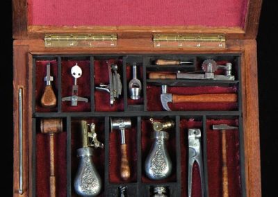 A miniature boxed set of gunsmithing tools.