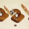 All three of Mr. Gasparin's small CO2 engines are on custom wooden stands with a pressure tank mounted to the base.