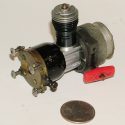 A Cox .049 engine with pull start and clutch.