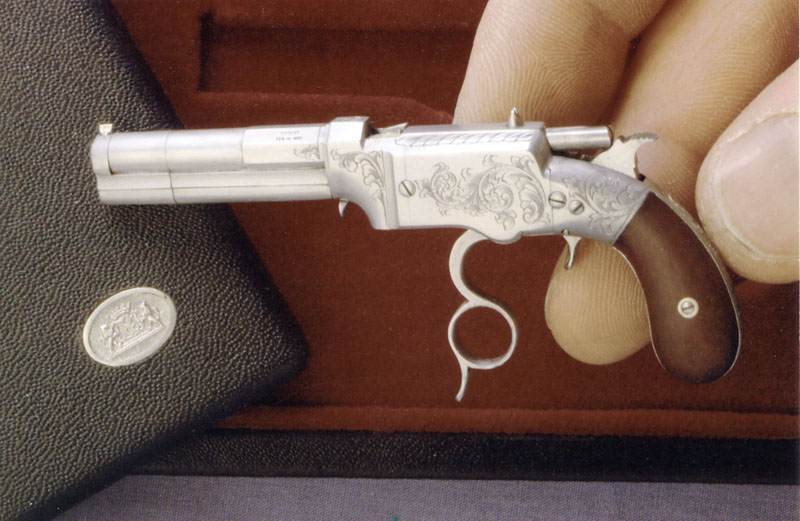 The miniature Volcanic Pistol with the trigger guard in position as the cocking mechanism. 