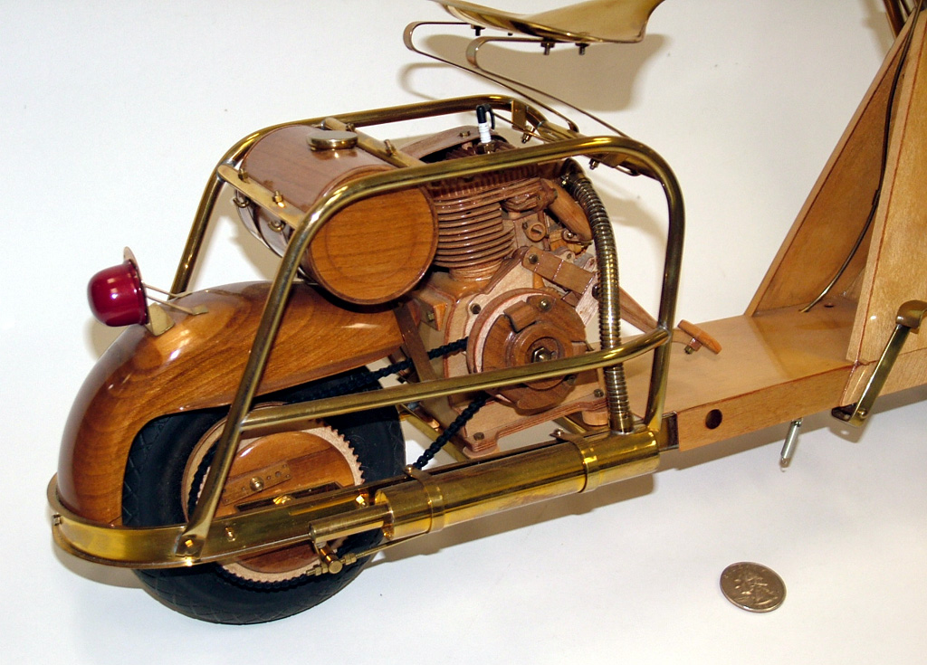 A 1/4 scale Cushman 711 scooter made from wood and brass.