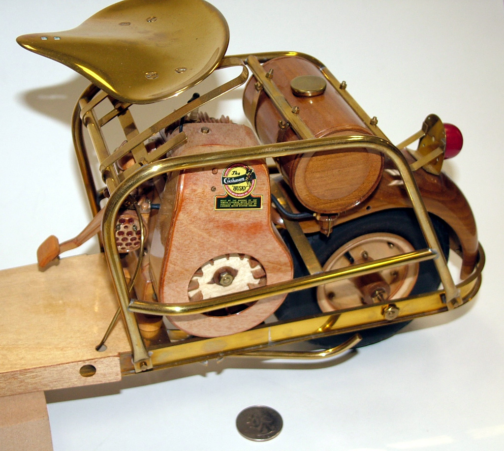 A 1/4 scale Cushman 711 scooter made from wood and brass.