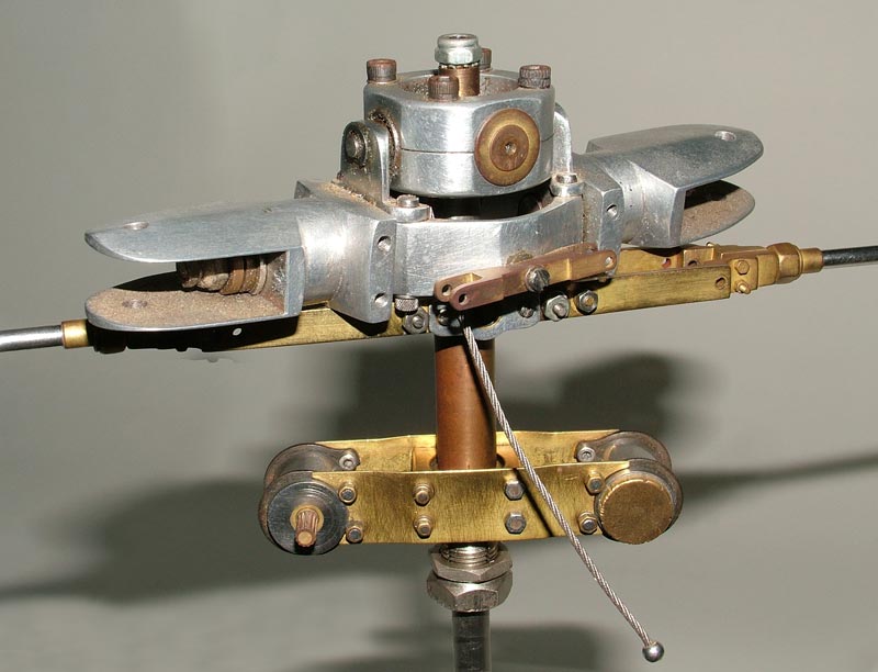 A brass and aluminum miniature Bell helicopter rotor mechanism.