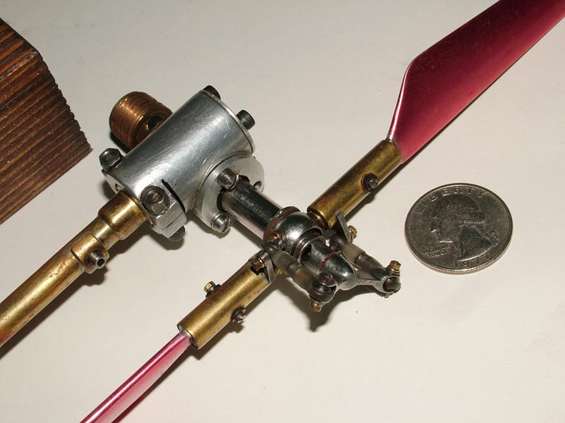 A brass and aluminum miniature Bell helicopter rotor mechanism.