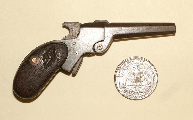 A miniature .22 single shot pistol.
