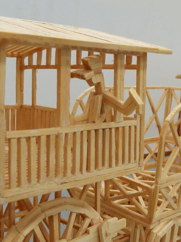 This model steam locomotive with passenger car and tender was made entirely from matchsticks.