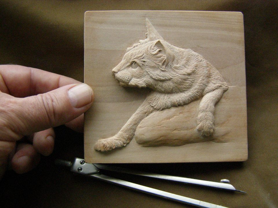 Carved Wooden Relief Even the texture of fur is evident on this tiny carved feline.