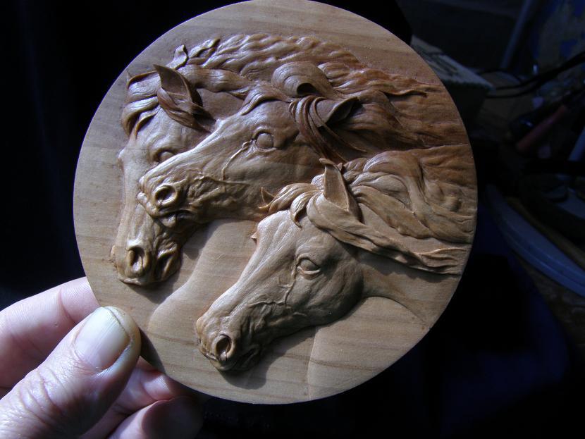 Carved Wooden Relief Vladimir includes a wealth of detail in his work. Notice the veins in the horses' faces.