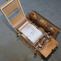 This fascinating hand-cranked box organ plays musical rolls.