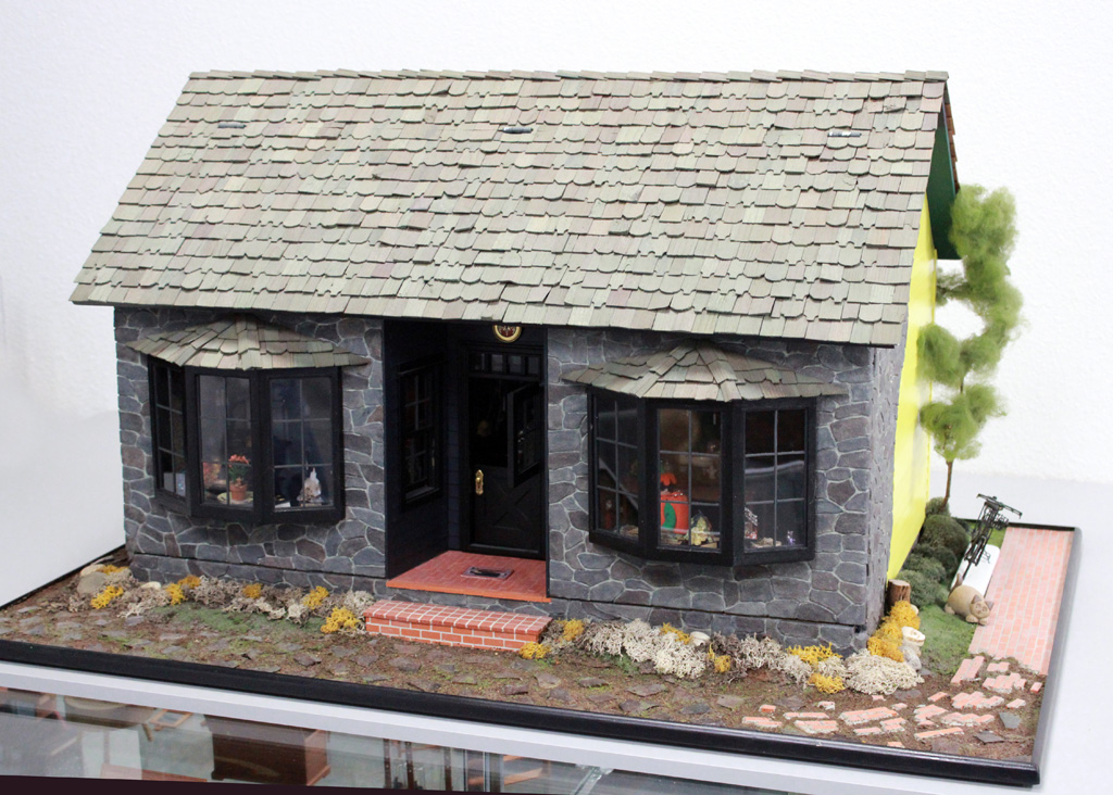 This 1/12 scale 2-story dollhouse is called, “Witch’s House.” A few miniature trick-or-treaters can be seen daring to approach the wrinkled witch.