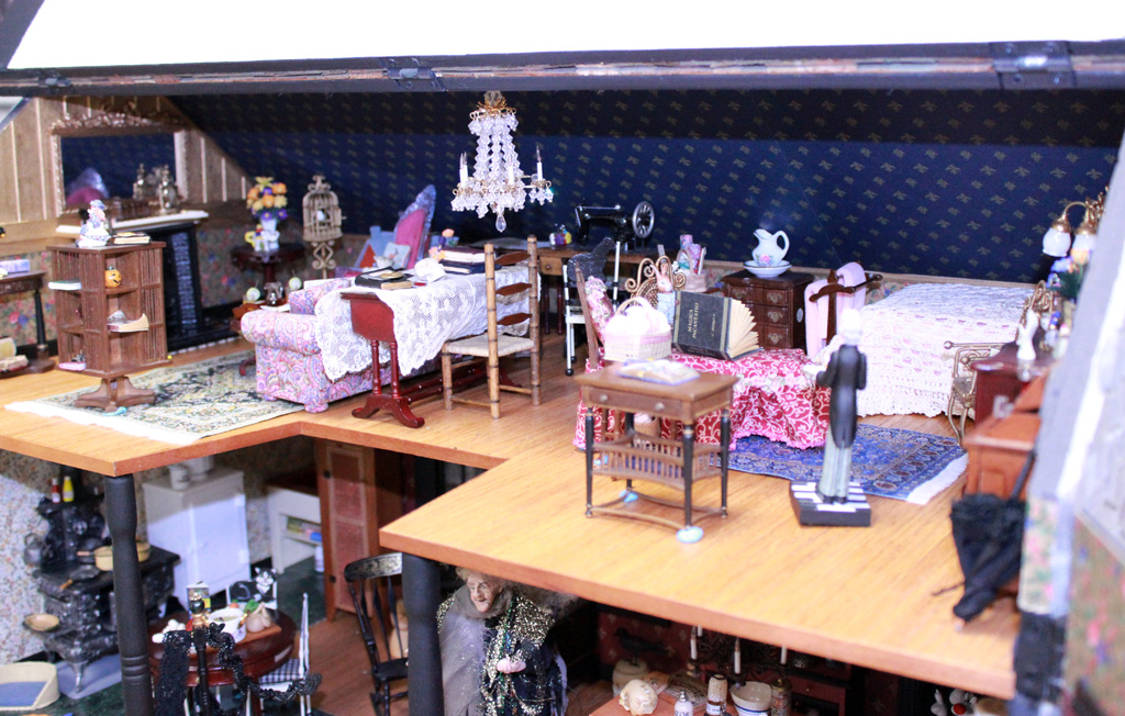 This 1/12 scale 2-story dollhouse is called, “Witch’s House.” A few miniature trick-or-treaters can be seen daring to approach the wrinkled witch.