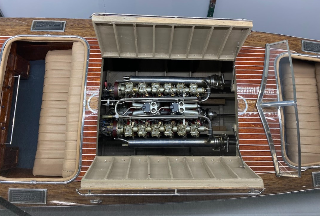 A peek inside the engine compartment reveals the 1/6 scale Liberty V-12 marinized aircraft engine.
