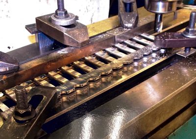 Profiling link rods.