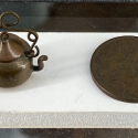 This extremely tiny copper teapot was formed using an old Indian Head penny.